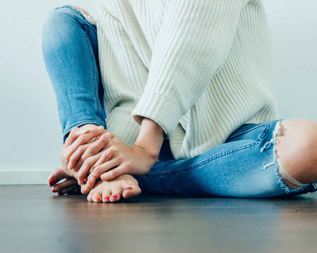 Person holding their foot